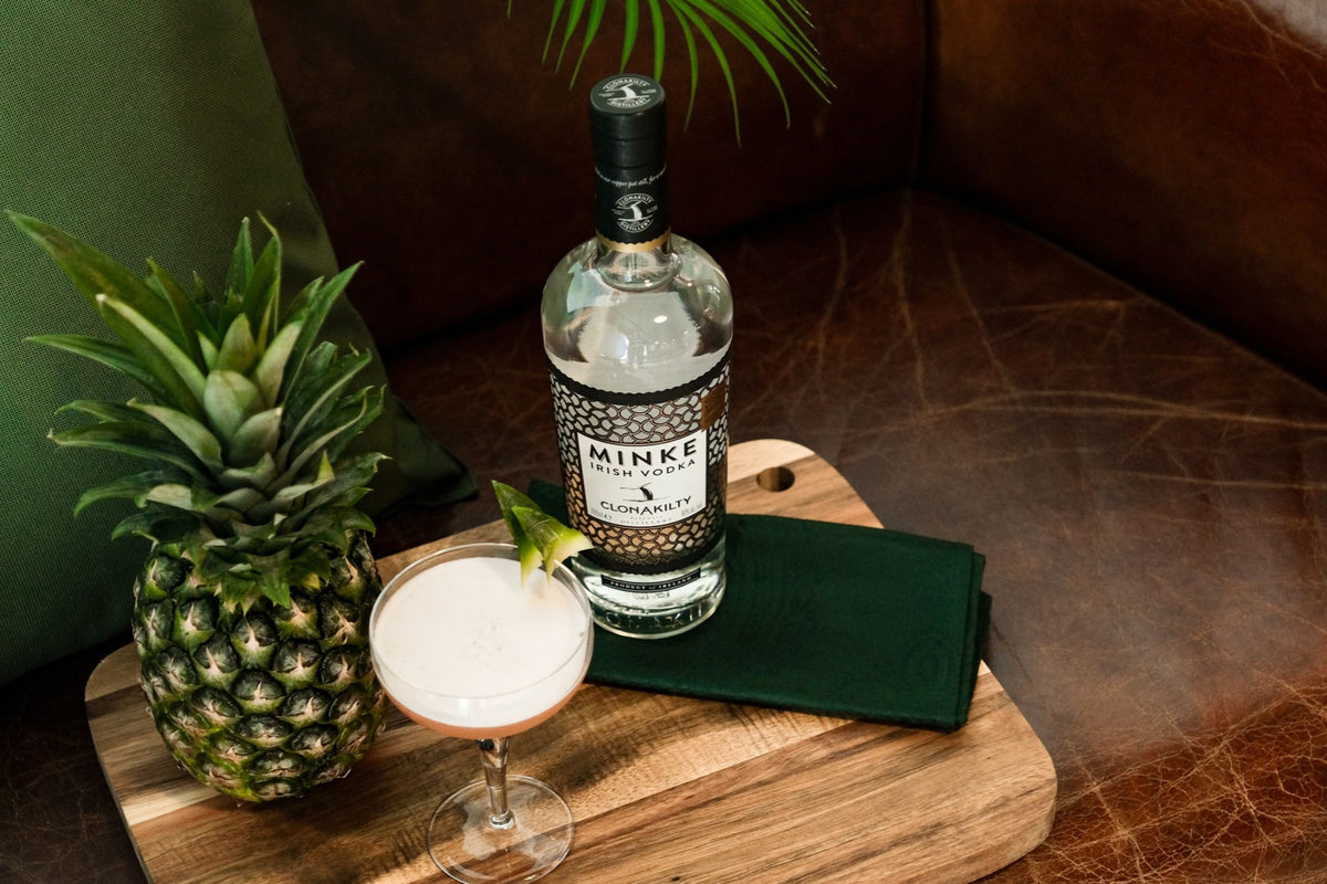 Minke Irish Vodka cocktail with fresh pineapple on a wooden board